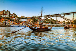 Rabelo boat on the Douro River, with D Luís bridge and Ribeira neighborhood in the background.